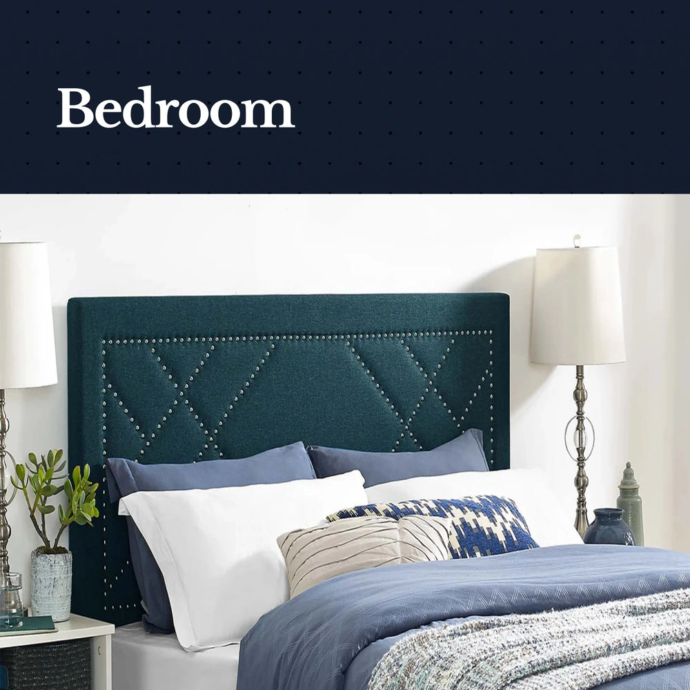 Bedroom with a teal upholstered headboard and decorative pillows.
