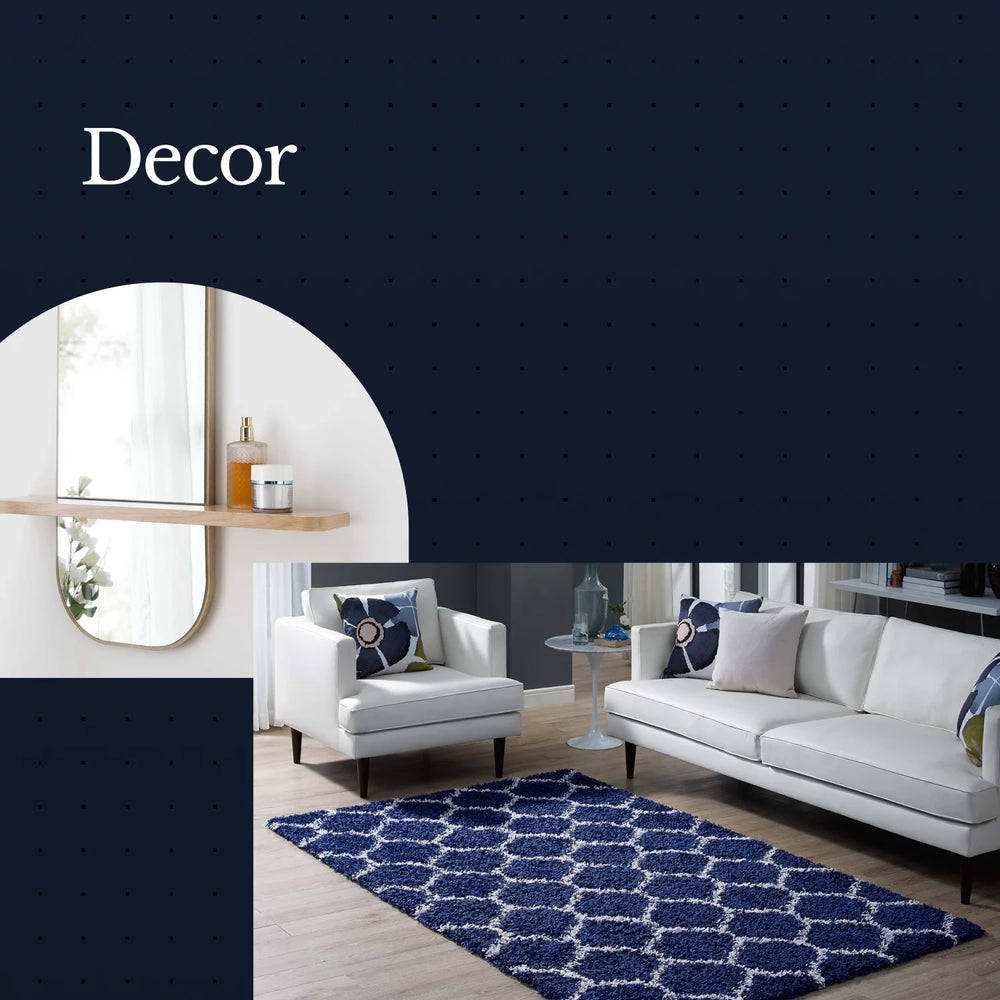 Living room with white furniture and a blue patterned rug, featuring the word 'Decor'.