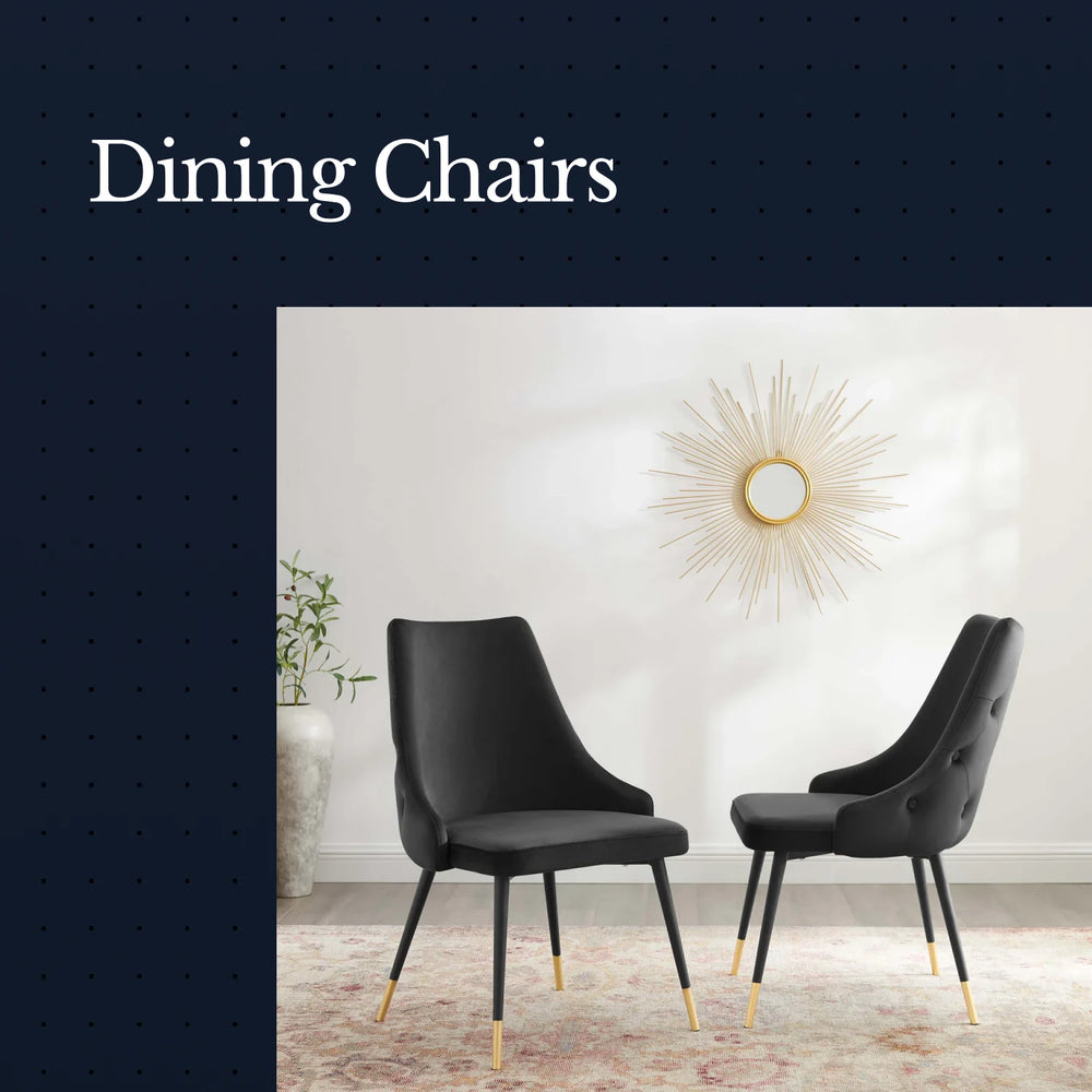 Two black dining chairs with gold legs in a room with a decorative wall mirror.