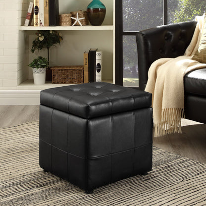Black leather ottoman in a living room setting with a couch and decor items.
