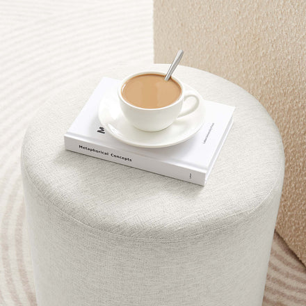 Callum 16" Round Woven Heathered Fabric Upholstered Ottoman in Heathered Weave Ivory