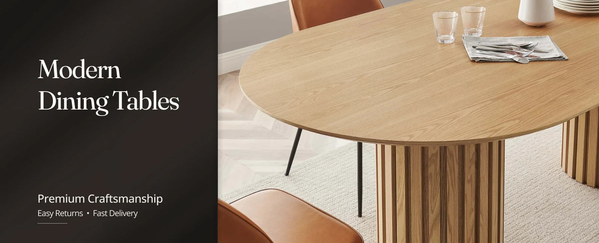 Modern oak dining room table with a rectangular top and upholstered chairs in a bright dining room.