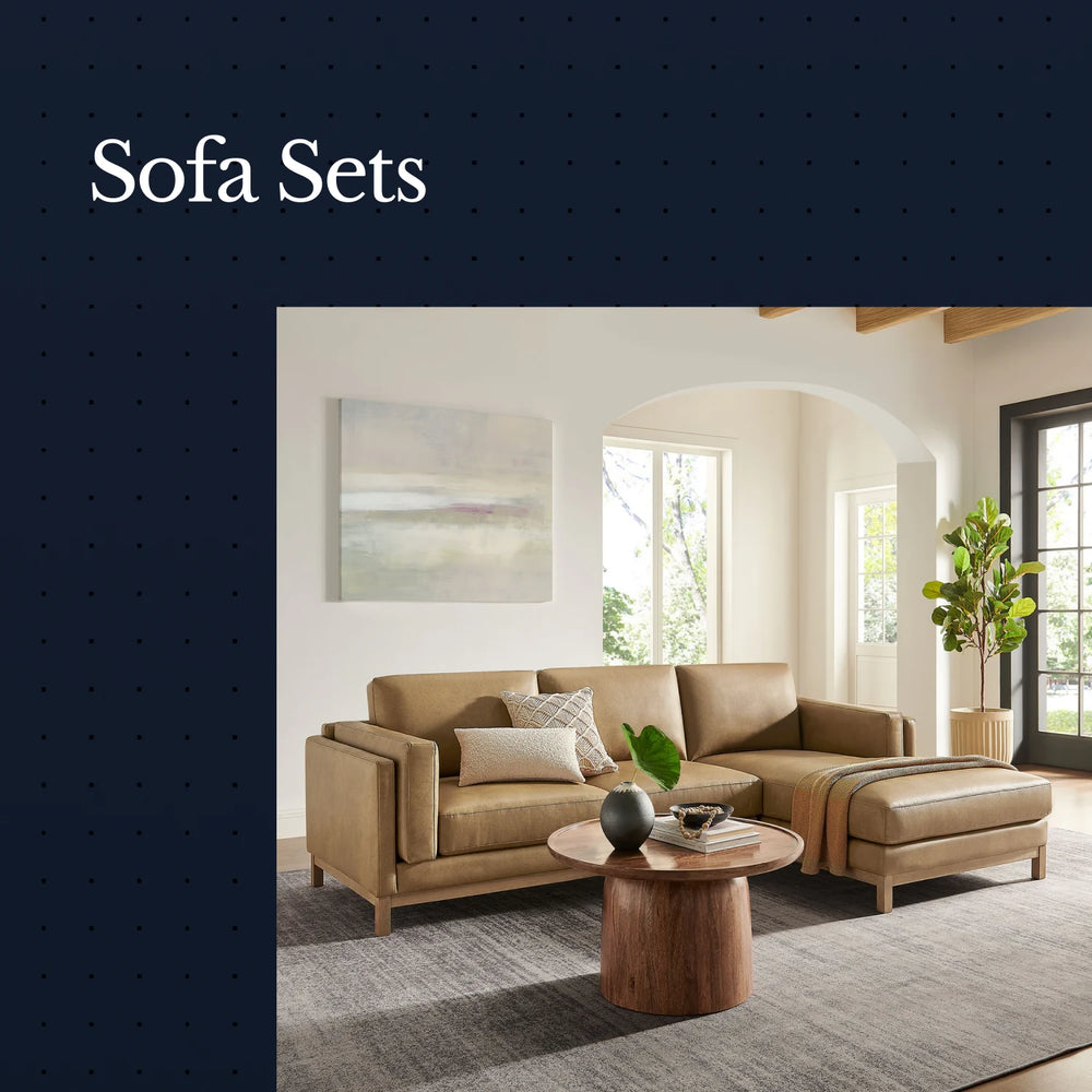 Beige sofa set in a living room with a coffee table and decor items.