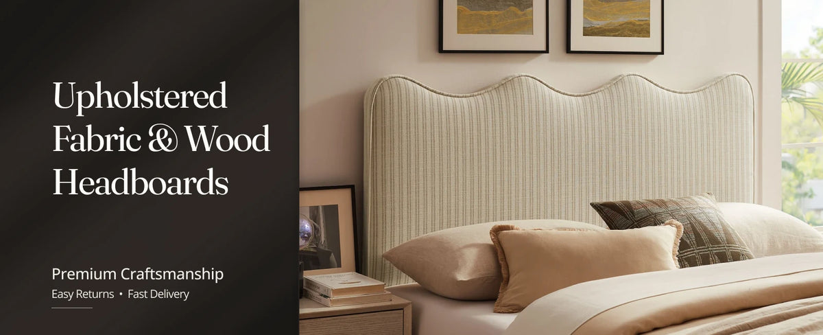 Gray upholstered headboard on a queen platform bed with matching nightstands and table lamps.